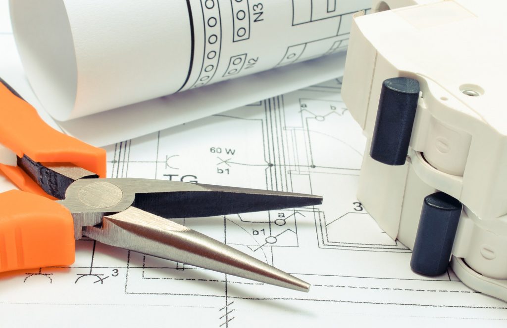 Electrical diagrams, electric fuse and pliers on construction drawing of house